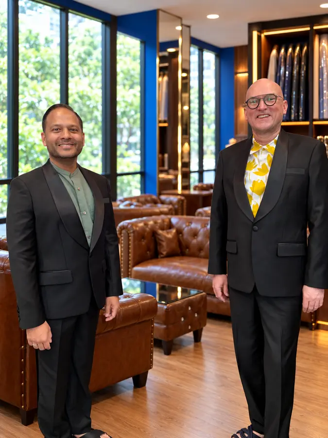 Two customers in dark tailored looks from the Sawasdee customer style collection